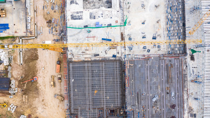 Aerial top view construction site with industrial consgruction machinery building for new  factory buildings.