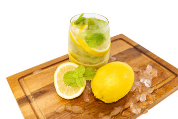 Fresh Fruit Yellow lemon in glass on wood for hot summer days and good for health isolated white background