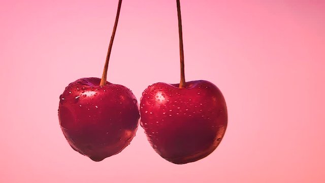 cherry berries cut, spraying juice to the sides. slow motion