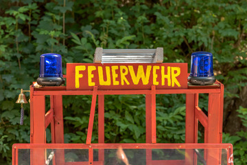 At a street party, a fire engine is ready for the children. The sign says in German fire engine. Concept: Animation for the kids