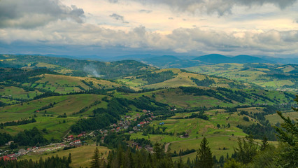 Beautiful mountain landscape in the summer with a small village in the valley