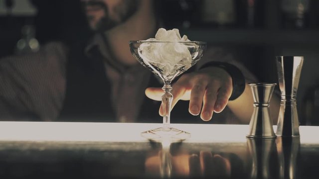 Barman make a cocktail on a bar