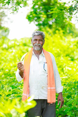 young indian farmer working at field