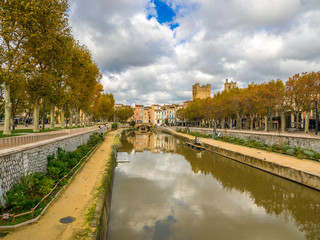 Canal de la Robine, a UNESCO World Heritage Site, as it passes through the city of Narbonne. Detail of the bridge covered with houses, le pont des Marchands. 