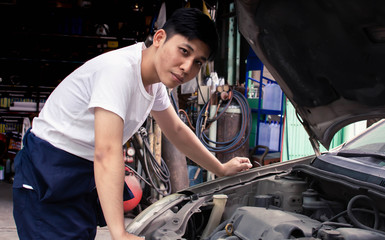 Fototapeta na wymiar A man is fixing machine of car