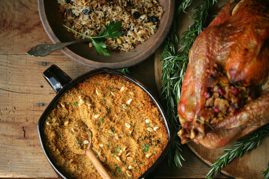 Overhead view of pilaf and spices with stuffed turkey