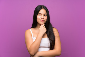 Fototapeta premium Young teenager Asian girl over isolated purple background laughing