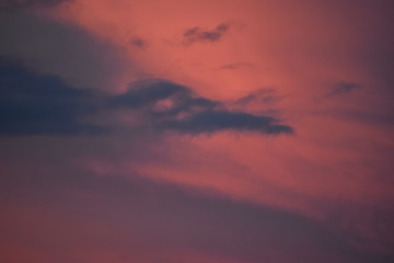Dark clouds in an orange colored sky before rain