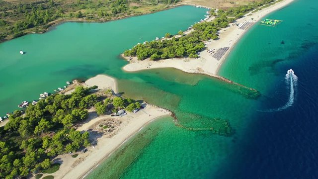 Aerial drone video of iconic sandy protected bay of Glarokavos with turquoise clear sea, Kassandra Peninsula, Halkidiki, North Greece