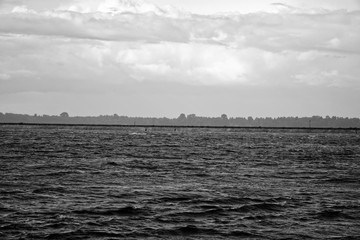 Spit or sandspit in river for protection, cloudy grey weather, calm mood