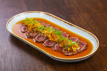 Beef tartare with sauce and herbs