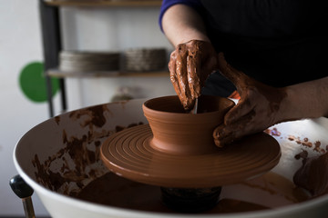 Fototapeta na wymiar Potter forming clay on a wheel