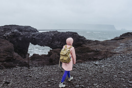 Icelandic black sand beach. Amazing lanscape nature in Iceland. Woman travelling with travel bag