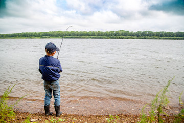 little fisherman pulls fish