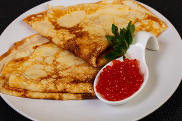 Pancake with red caviar