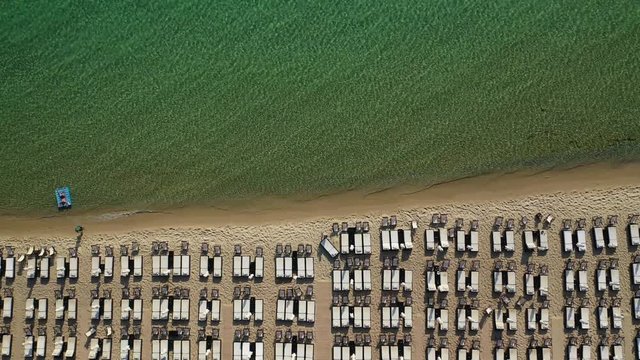 Aerial drone view video of iconic sandy bay and turquoise beach of Paliouri in Kassandra Peninsula, Halkidiki, North Greece