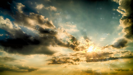 Sunset against a backgrond of dramatic sky and dark clouds