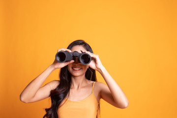 Young Asian woman with binoculars.