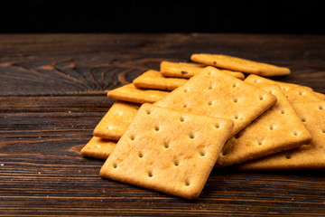 Cracker cookies with onion dark wooden background.