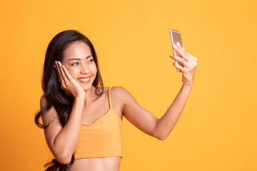 Naklejka premium Young Asian woman selfie with mobile phone.