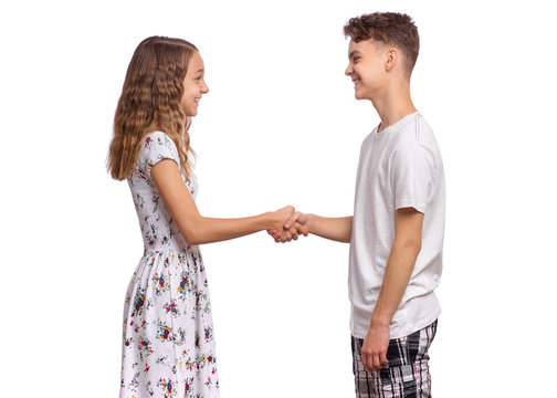 Portrait of happy teen boy and girl handshaking. Brother And sister with smile shake hands. Young attractive couple isolated on white background. Friendship and love concept.