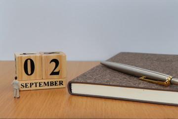 September  2, a calendar photo from the wood The table top consists of a book and pen that is ready...