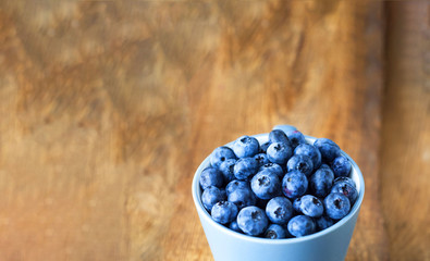 Blueberry on old wooden boards. Natural surface texture for design background