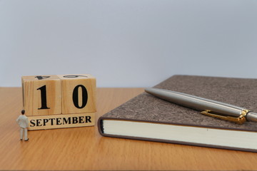 September  10, a calendar photo from the wood The table top consists of a book and pen that is...