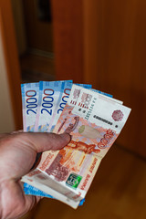 Five and two thousand rubles banknotes, on the left hand