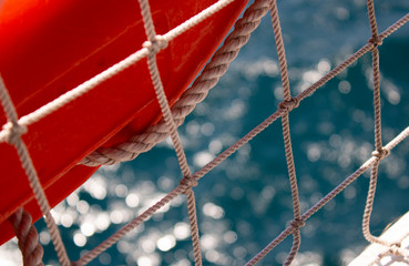 Fototapeta na wymiar lifeline, rope net and side of an old historic ship in close-up