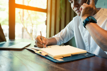 The young man, the owner of the business, is calling his client's phone back to make an appointment...