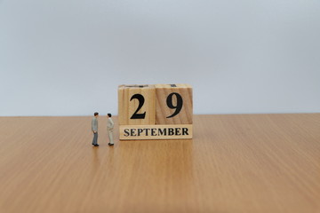 September  29, a calendar photo from the wood The table top consists of a book and pen that is ready to use. White background