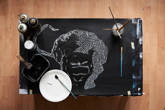 Overhead of artist studio with painting in progress