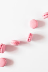 Pink macaroons on white background. Sweet background. Flat lay, top view, copy space