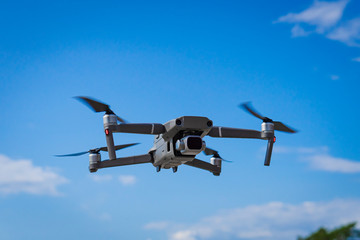  Drone hovering in nature over blue sky