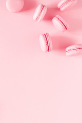 Pink macaroons on pink background. Sweet background. Flat lay, top view, copy space