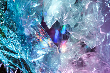 Holographic background in the style of the 80-90s. Real texture of cellophane film in bright acid...