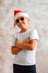 Obraz na płótnie Canvas an eight-year-old boy in a Christmas hat