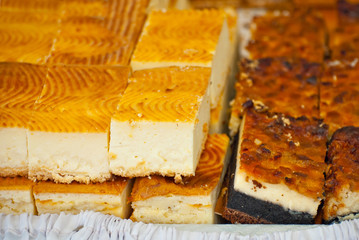 Round cake with red stuffed in a shop window.  Cake cut into pieces.
