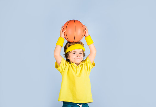 Basketball training. Child boy in sportswear throws ball. Active sports lifestyle. Sport game. Kid activities. Little basketballer. Sports equipment. Cute boy playing basketball. Enjoy sport game.