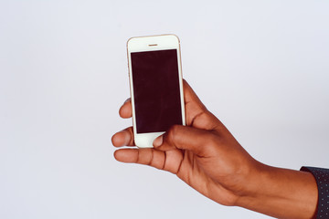 Male hand holding smartphone with blank screen.