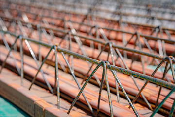 Close up on lattice girder and truss girders steel roof truss for concrete precast with ceramic elements ready for installation on the construction site or warehouse