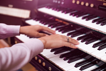 Organist playing a pipe organ, closeup view