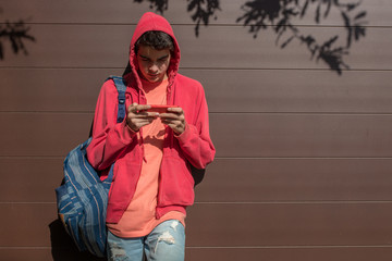 young student with mobile phone outdoors