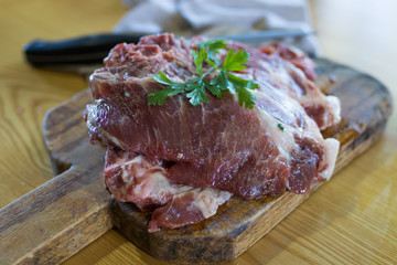 fresh veal chop meat on wood
