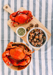 Top view of Steamed Giant Mud Crabs in wooden bowl served with Thai spicy seafood sauce and Grilled...