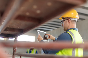 Architect using laptop at construction site