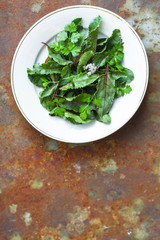 mix salad leaves in a plate (fresh green snack). food background. top