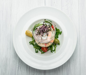 salad of seafood and vegetables with arugula and tomatoes