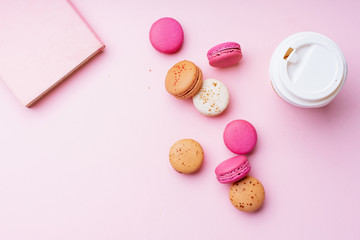 Flatlay with colorful macarons on pink background. Top view